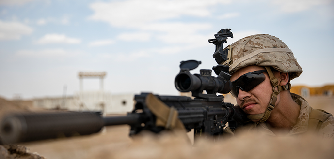 marksman holding gun with scope