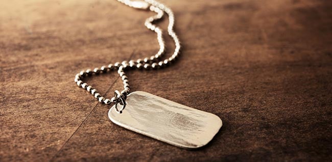 old military dog tag on surface