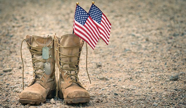soldiers boots with dog tags and american flags