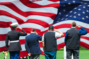 Veteran's Saluting Large American Flag