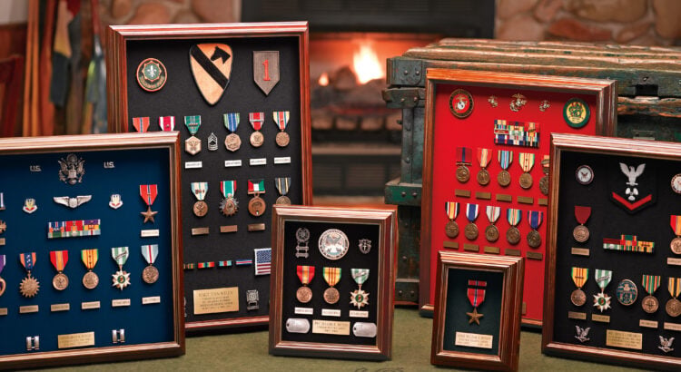 Military medals displayed in shadow boxes and frames arranged neatly for home display